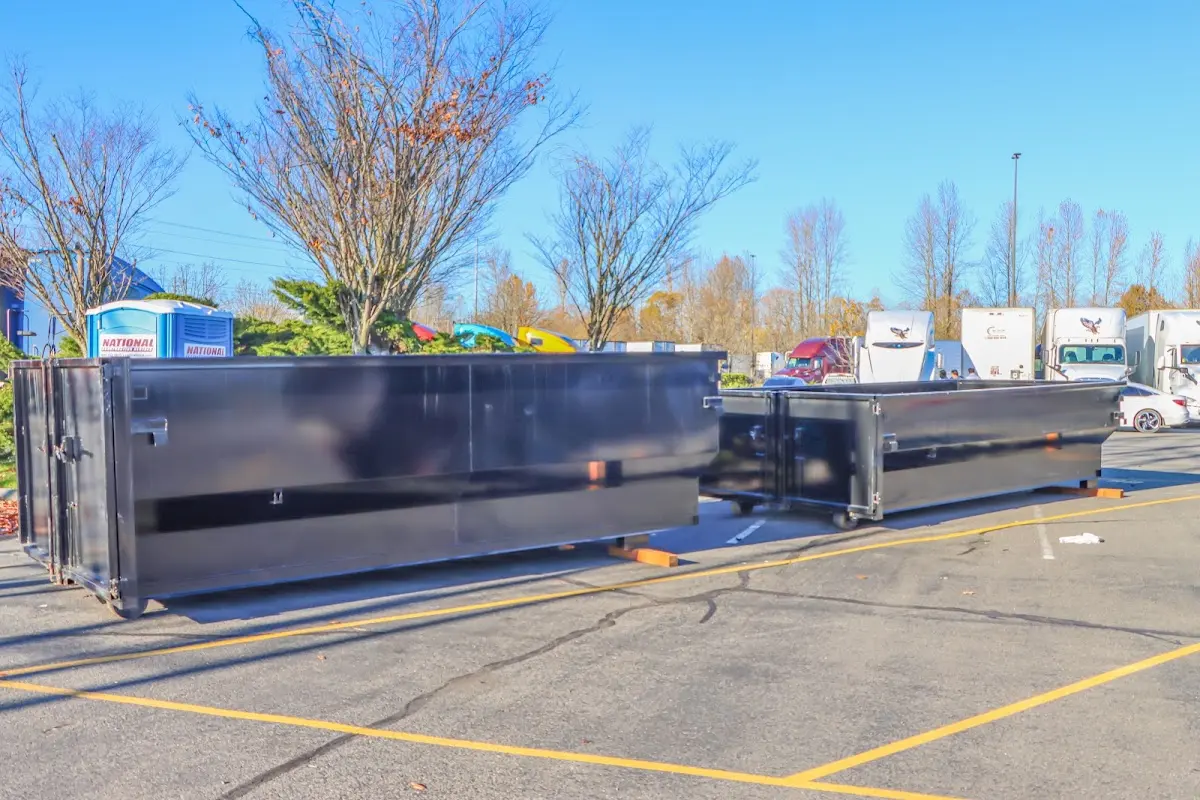 Professional dumpster rental service with roll-off container on residential driveway in Tulsa